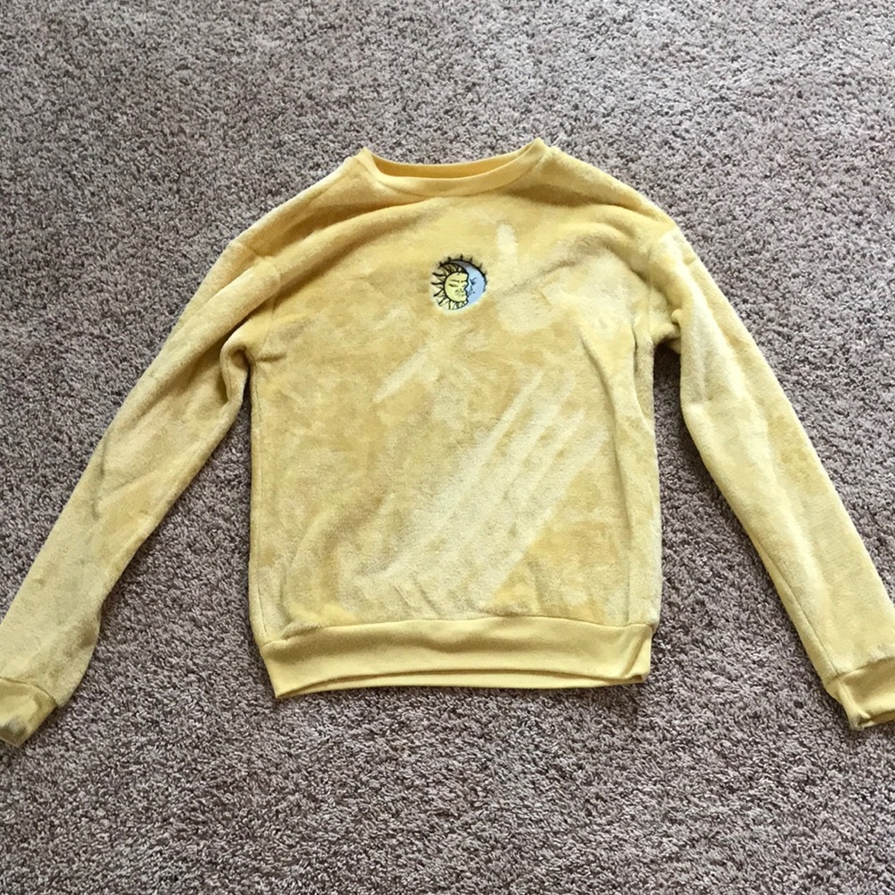 yellow sweater with sun and moon on it
